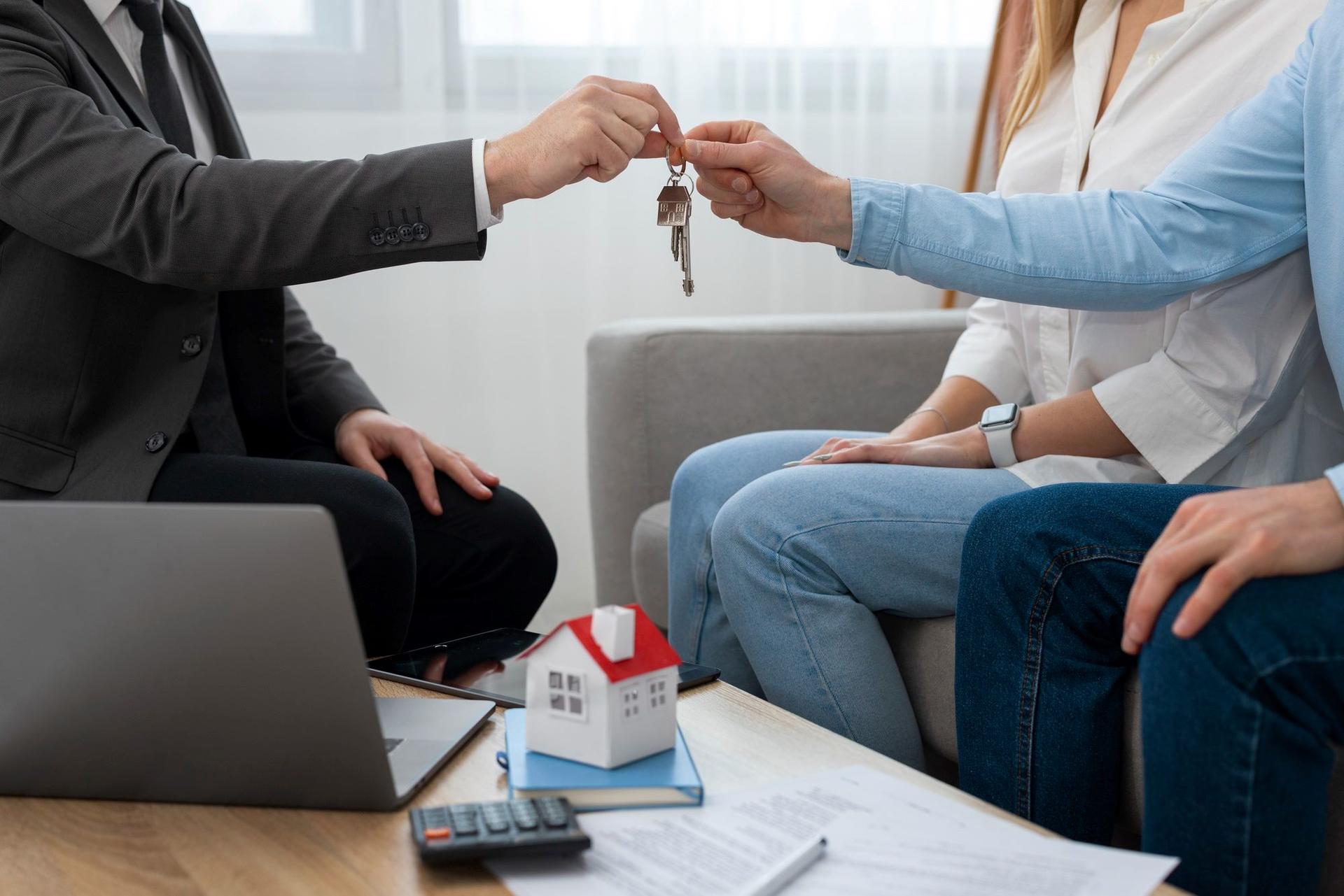 Man handing another man keys